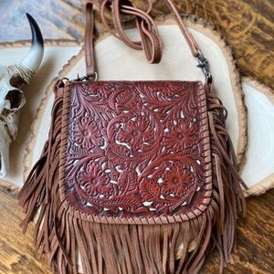 Western tooled leather crossbody fringe purse.
